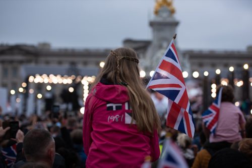 A girl holds the British flag amongst a crowd of fans during the Queen Elizabeth II Platinum Jubilee, Pageant