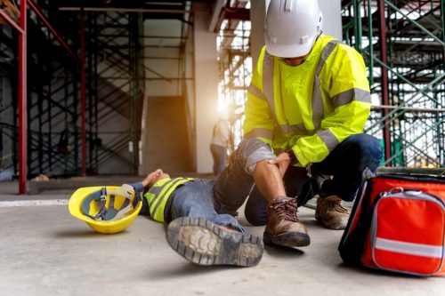 First aid support accident at work of construction worker at site.
