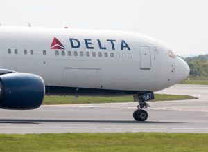 A Delta Air Lines jet taxiing on the runway at an airport