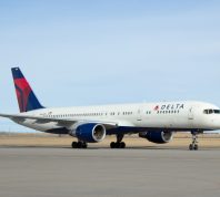 A Delta Air Lines plane sitting on the runway at an airport