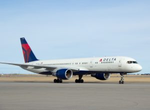 A Delta Air Lines plane sitting on the runway at an airport