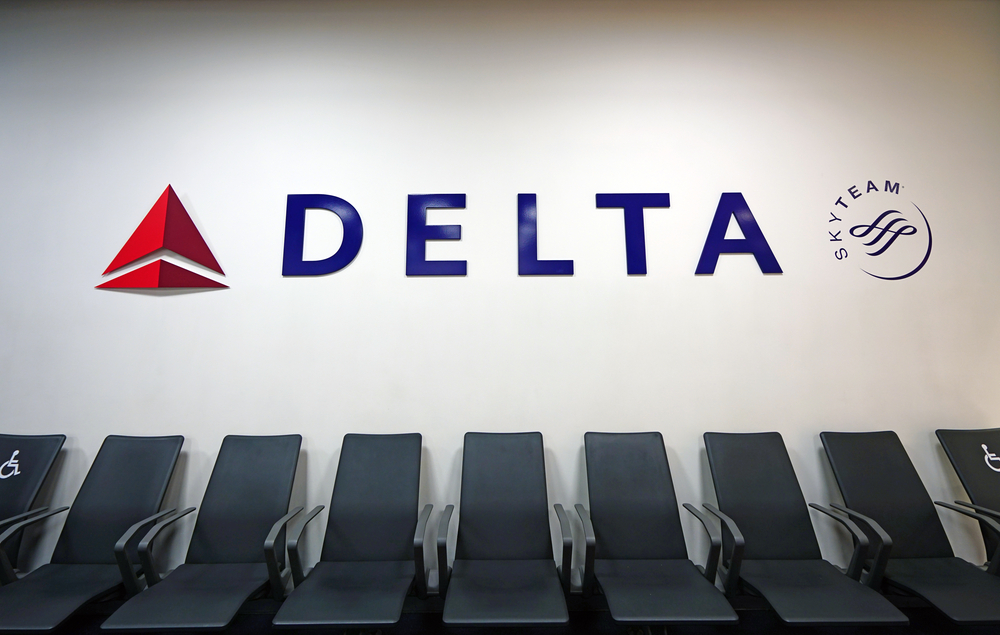 A Delta sign above seats in an airport terminal