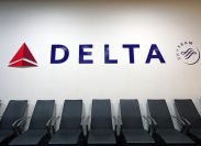 A Delta sign above seats in an airport terminal
