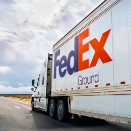 FedEx Ground truck driving on the interstate