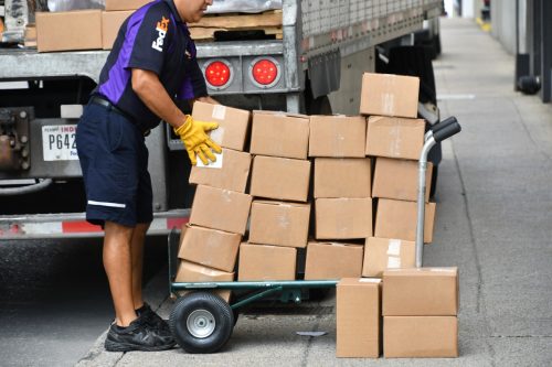 Nashville, TN USA - Sept 9, 2018: FedEx employee unloading boxes for delivery, shipping logistics