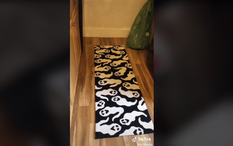 A black and white rug with images of ghosts on it