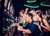 A group of friends playing slot machines