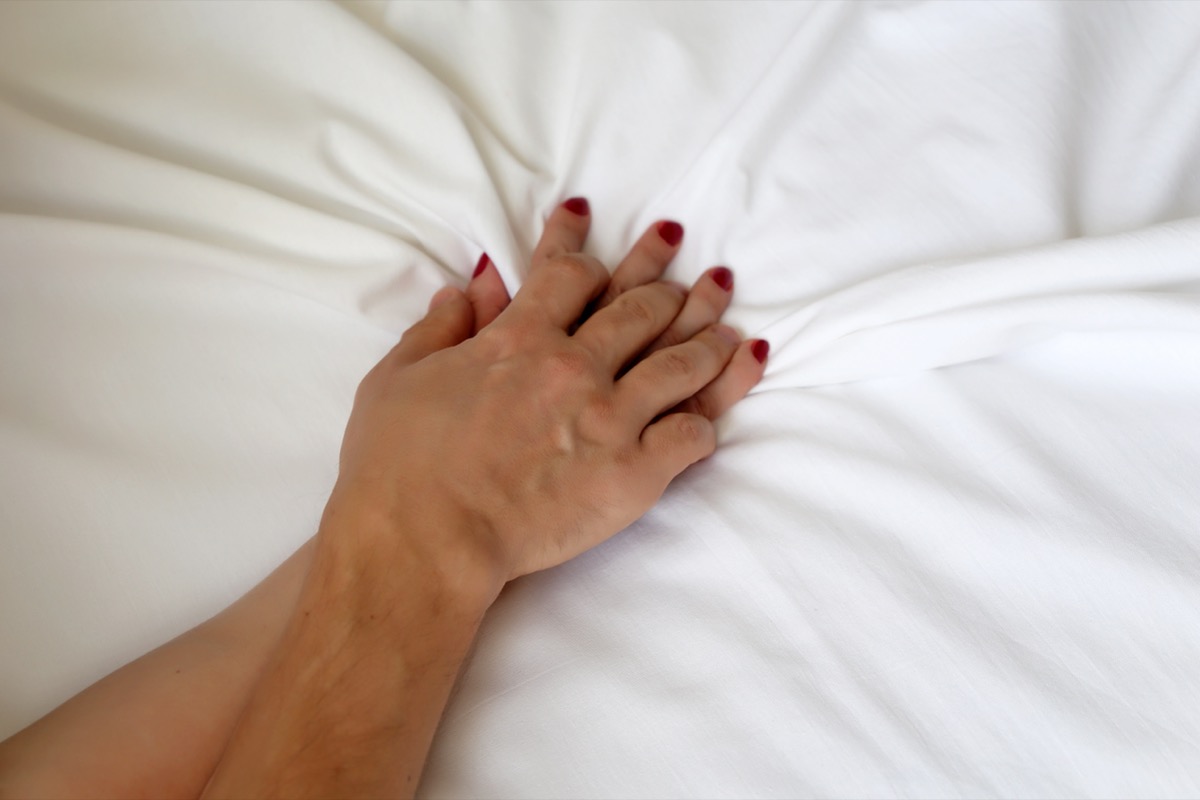 Hands Grasping White Sheets