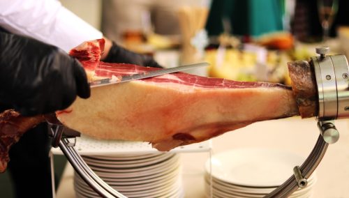 Traditional cut of Iberian ham with a knife.