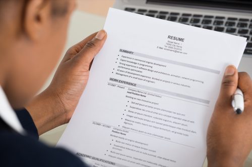 Close-up Photo Of A Businesswoman Holding Resume