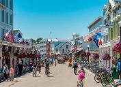 The main street of Mackinac Island, Michigan, filled with people and decorated for July 4th.
