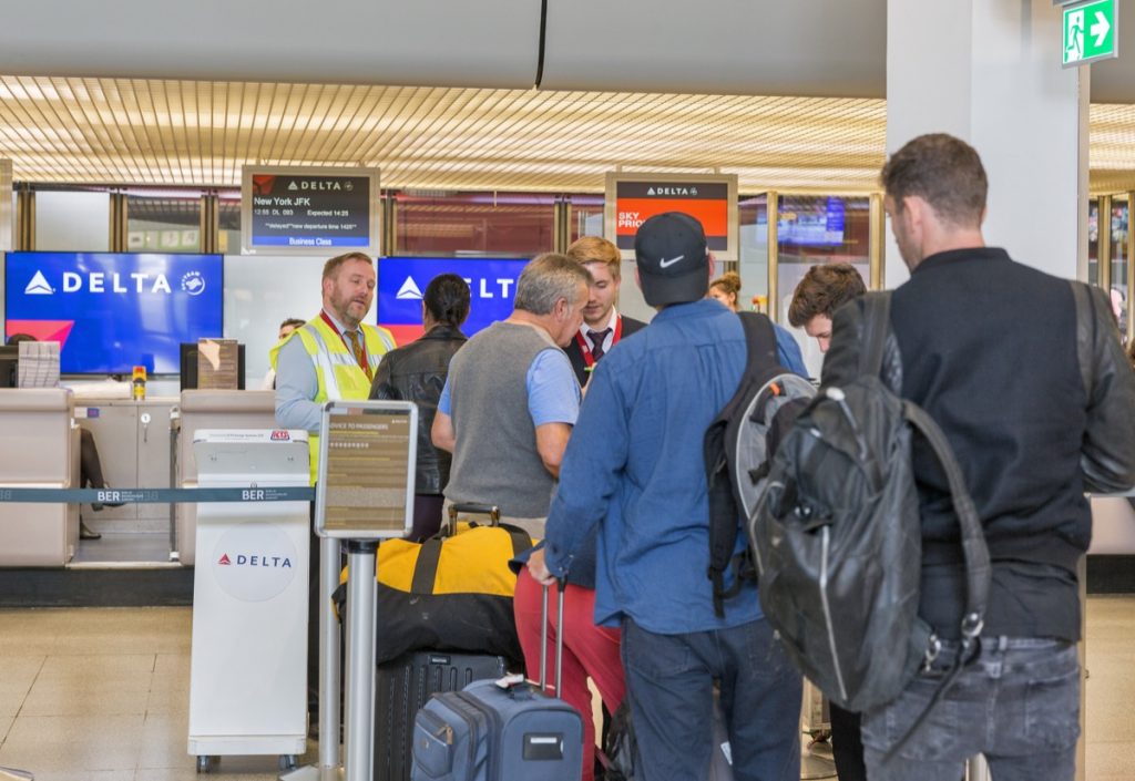 Passengers check in with luggage for flight to New York JFK at the Delta Air Lines desk in Tegel Airport, the main international airport of the capital of Germany.