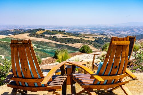 Two wooden chairs for a wine tasting venue overlooking Paso Robles vineyards