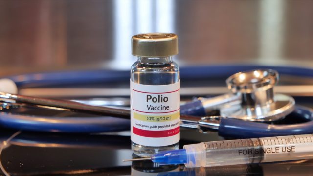 Via of Polio Vaccine on a stainless steel background