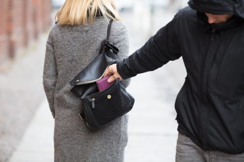 Close-up Of A Person Stealing Purse From Handbag