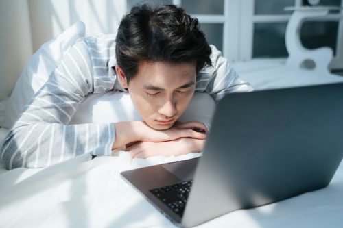 Man Falling Asleep at His Laptop