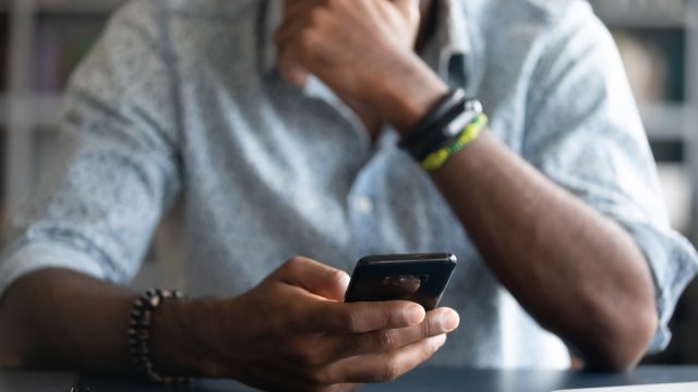 man looking at text on phone