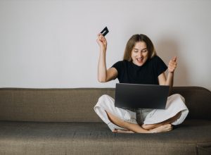 Woman Excitedly Online Shopping