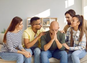 Group of People Comforting a Friend