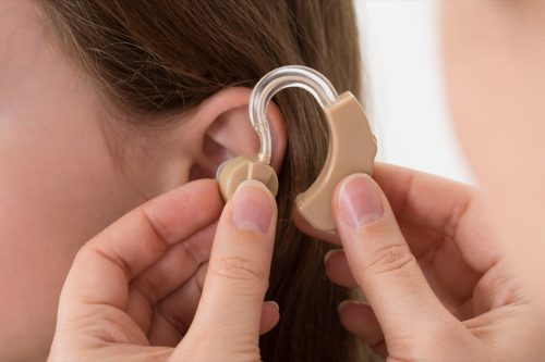 putting hearing aid on