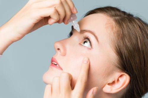 Woman Putting Drops in Her Eyes