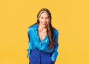 stacy london against a bright yellow background