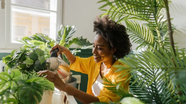 young black woman with houseplants