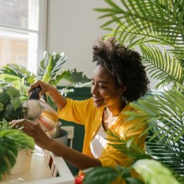 young black woman with houseplants