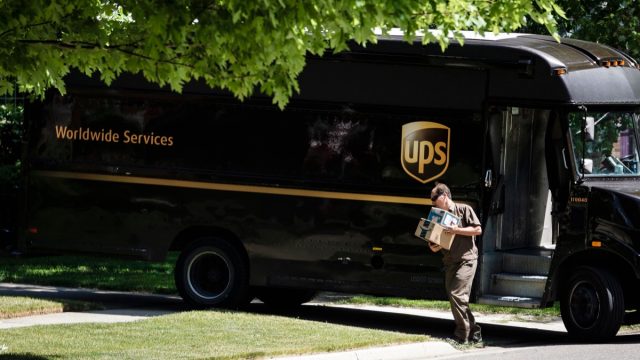 A UPS driver making a delivery to a residence in Rochester.