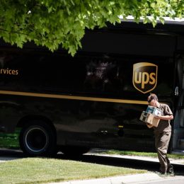A UPS driver making a delivery to a residence in Rochester.