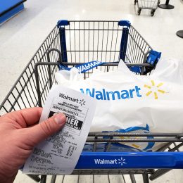 Walmart shopping cart with bag and receipt in Walmart store
