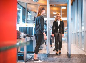 A woman passing through a metal detector at airport security