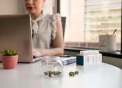 Female Cannabis Entrepreneur working on Marketing for Marijuana Business in Bright, Soft Lit Office