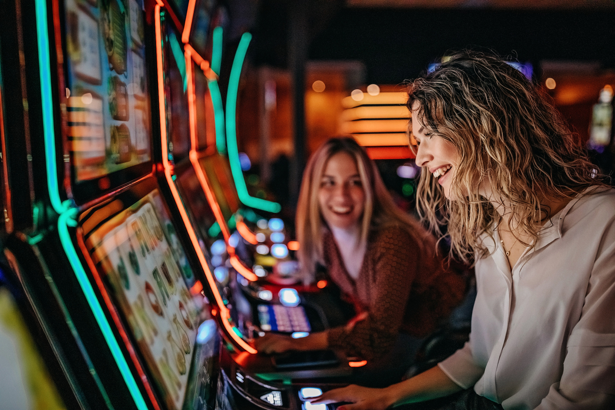Young women playing slot machines in a casino