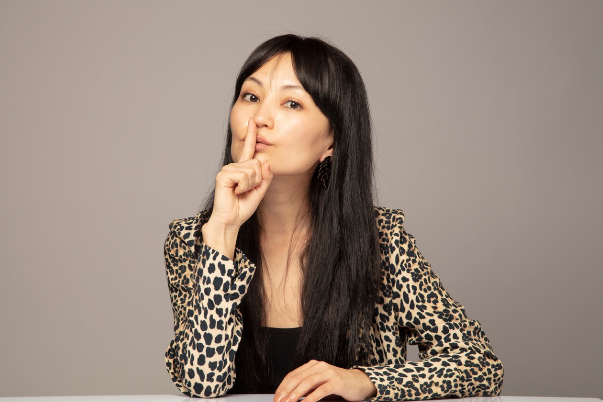 woman sshing camera with a secret