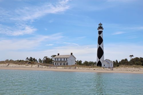 The black and white Cape Lookout Lighthouse on the Southern Outer Banks or Crystal Coast of North Carolina viewed from the water