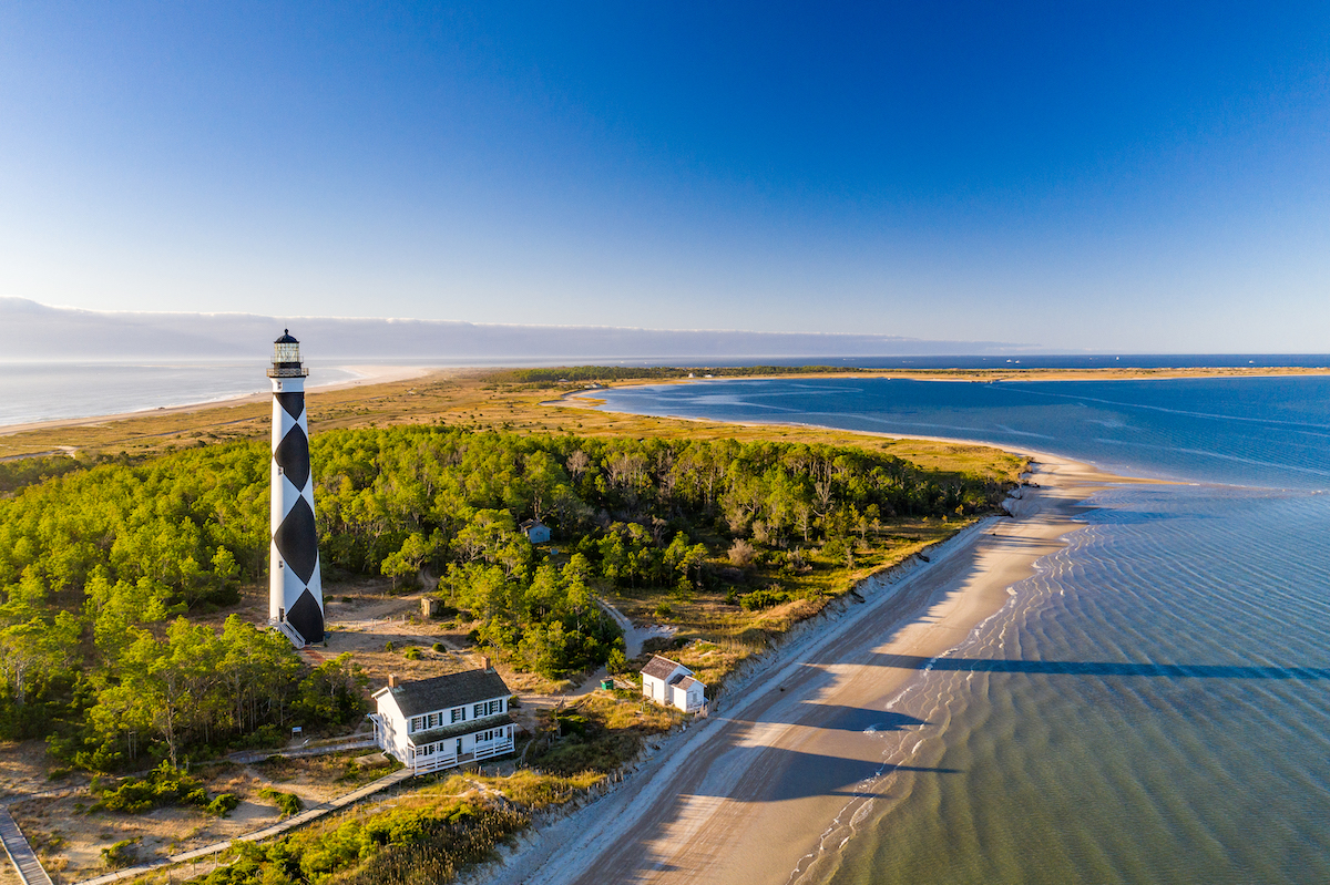 The black and white Cape Lookout Lighthouse on the Southern Outer Banks or Crystal Coast of North Carolina viewed from the water