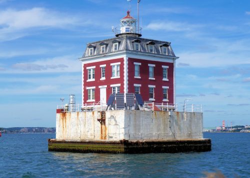 Connecticut's New London Ledge Lighthouse, a red brick structure in the middle of the water.