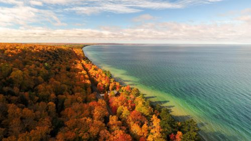 Traverse City Michigan with beautiful red-leaved trees and the water alongside