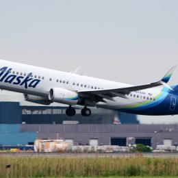 An Alaska Airlines plane taking off from an airport