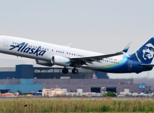 An Alaska Airlines plane taking off from an airport