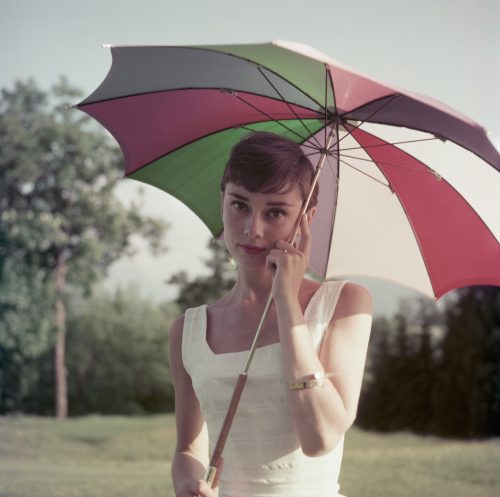 Audrey Hepburn photographed holding an umbrella in Switzerland in 1954