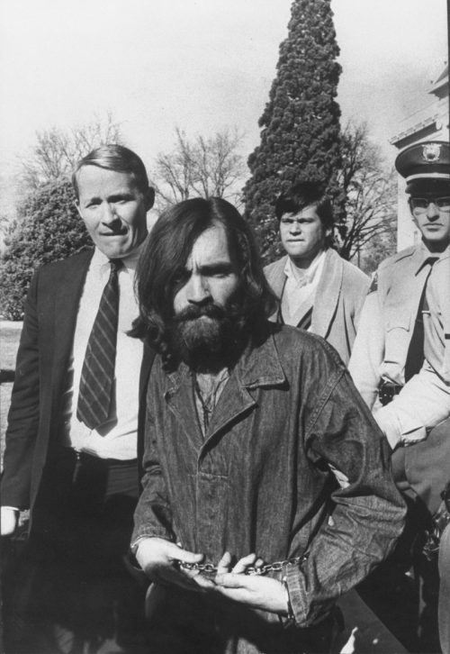 Charles Manson being led from a courthouse in 1969