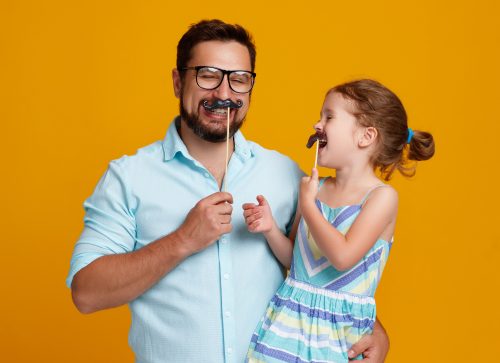 man and daughter with fake mustaches - corny dad jokes