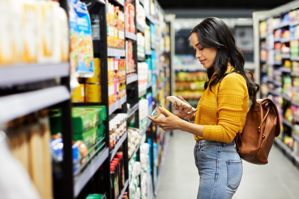 Shot of a young woman shopping for groceries in a supermarket