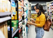 Shot of a young woman shopping for groceries in a supermarket