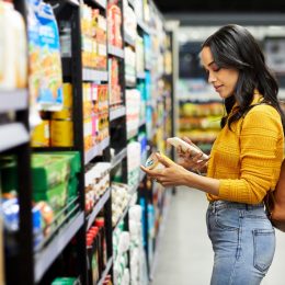 Shot of a young woman shopping for groceries in a supermarket