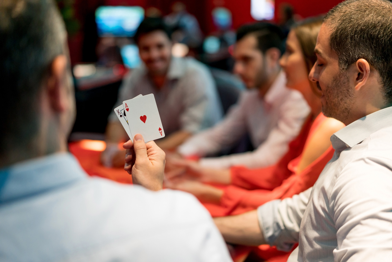 A group of people playing cards in a casino