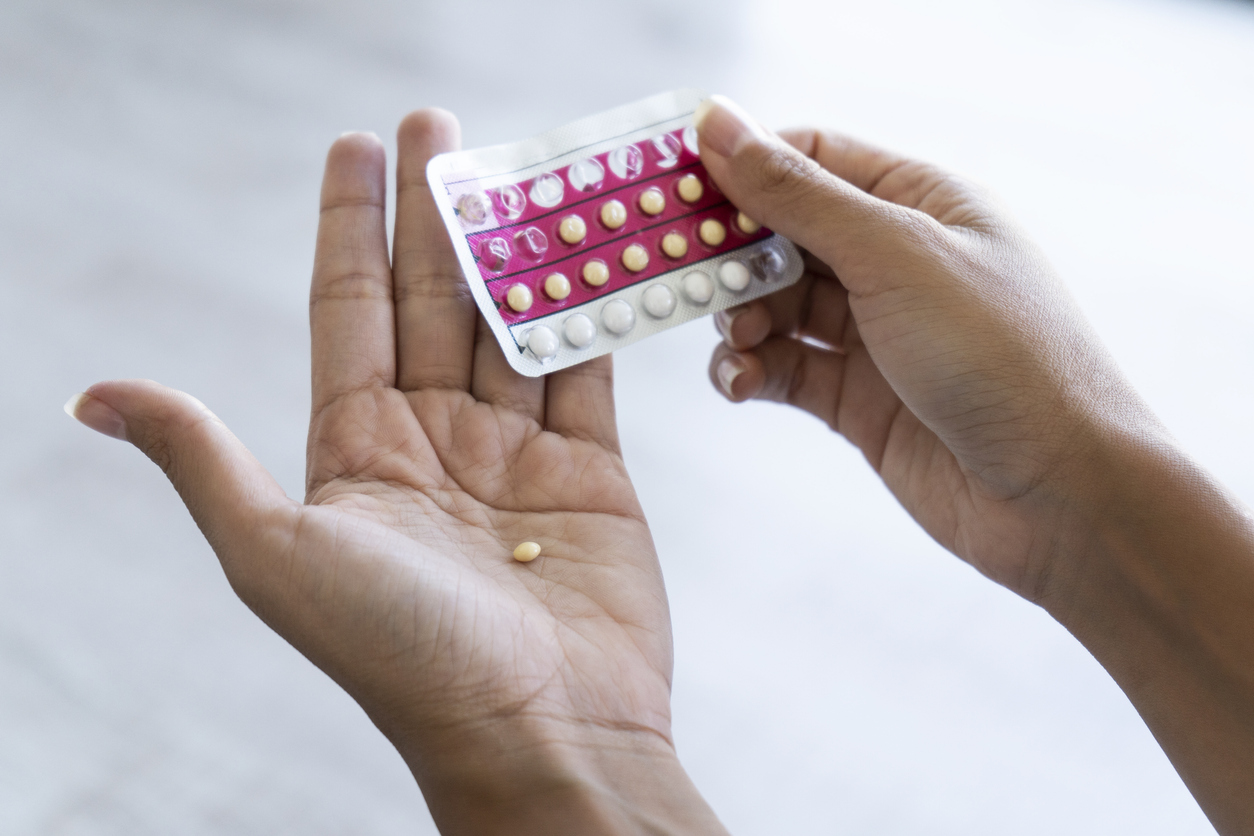 Woman holding a package of birth control pills.