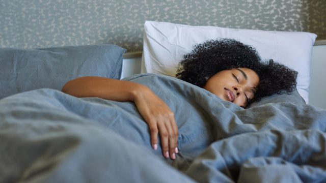 Woman sleeping peacefully in bed.